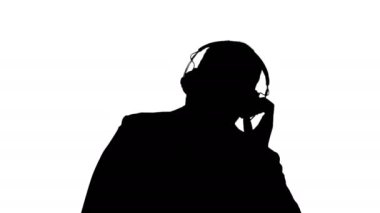 Siluet Siyah iş adamı kulaklıkla müzik eşliğinde dans ediyor.