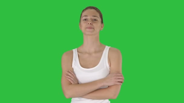 Smiling sports woman walking with arms folded on a Green Screen, Chroma Key. — Stock Video