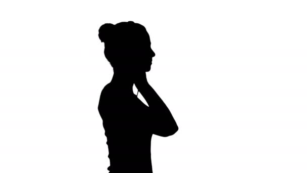 Silhouette Happy casual girl wearing headphones walking. — Stock Video