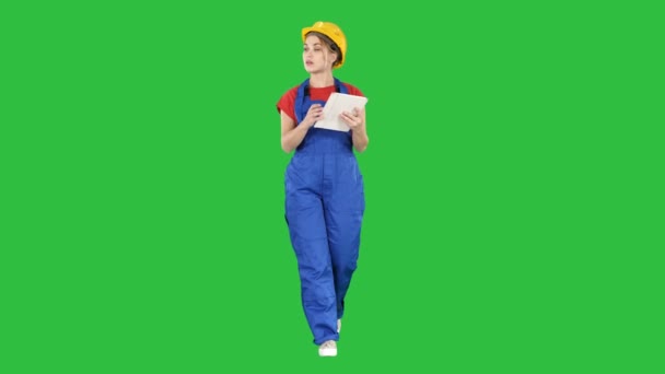 Woman construction worker with tablet checking construction site on a Green Screen, Chroma Key. — Stock Video