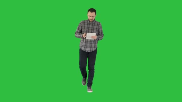 Um cara segurando e usando um comprimido branco em uma tela verde, Chroma Key . — Vídeo de Stock