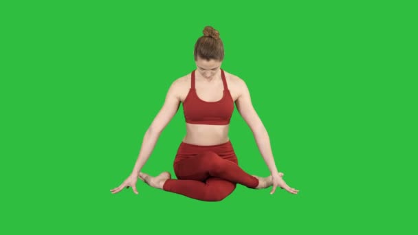 Yoga girl practicing nadi shodhana pranayama or Breathingin in gomukhasana asana or cow head pose on a Green Screen, Chroma Key. — Stock Video