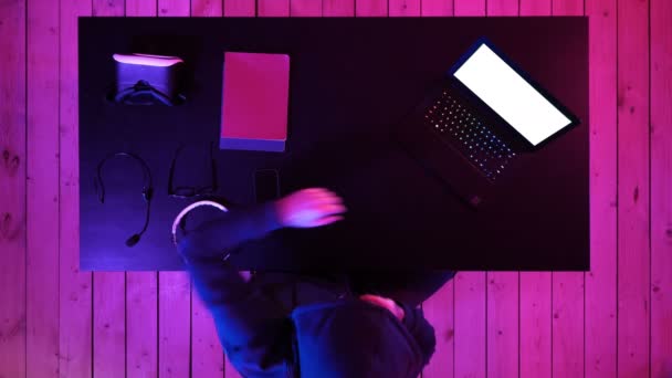 Cybercrime, hacking and technology concept - male hacker in dark room writing code or using computer virus program for cyber attack. White Display. — Stock Video