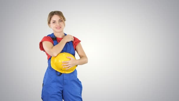 Construção mulher rindo de alguém atrás da câmera no fundo gradiente. — Vídeo de Stock