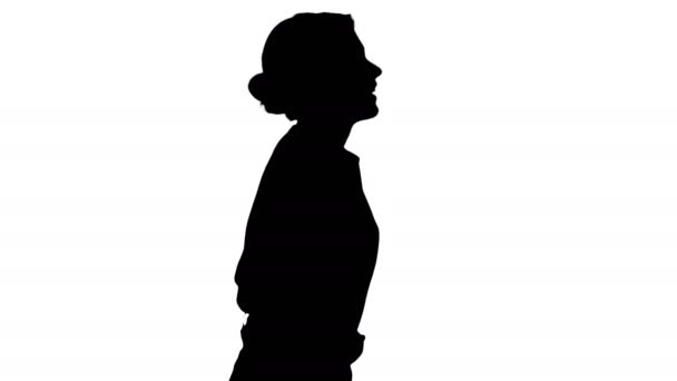 Silhouette Young beautiful girl with hands in pockets walking. — Stock Video