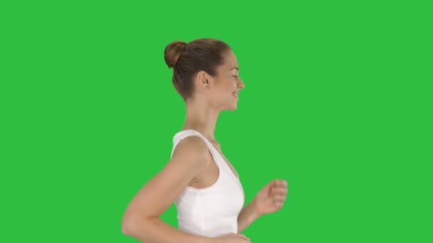 Fit νεαρή γυναίκα που τρέχει σε μια πράσινη οθόνη, Chroma Key. — Αρχείο Βίντεο