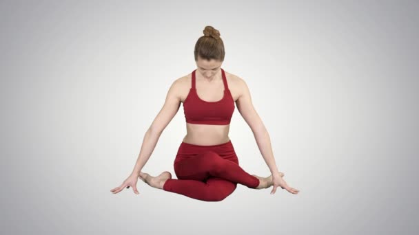 Yoga girl practicing nadi shodhana pranayama or Breathingin in gomukhasana asana or cow head pose on gradient background. — Stock Video