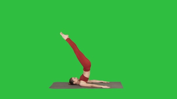 Beautiful sporty girl doing yoga exercises for abs strength, Supported Shoulderstand asana, Salamba Sarvangasana on a Green Screen, Chroma Key. — Stock Video