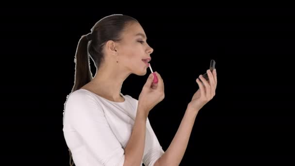 Mooie jonge vrouw zet op lippenstift, Alpha Channel — Stockvideo