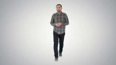 Tam boy portre. Gömlekli ve kot pantolonlu genç adam kameraya doğru yürüyor ve yan tarafları gösteriyor. 4K çözünürlükte profesyonel atış. 004. Kullanabilirsin, mesela. içinde