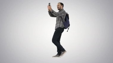 Genç çekici öğrenci backpacker turist selfie fotoğrafta cep telefonu ile üzerinde gradyan arka planı.