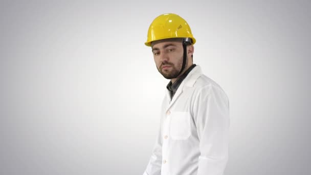 Unhappy construction site engineer talking and walking on gradient background. — Stock Video