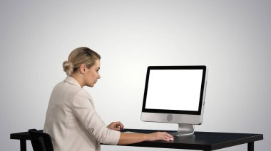 Business person works at table with computer on gradient background. clipart