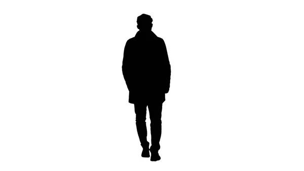 Silhouette Hombre con barba oscura en gabardina ligera camina. — Foto de Stock