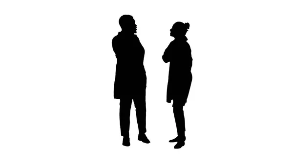 Silhouette Female and male doctor using mobile phones making calls telling happy news. — Stock Photo, Image