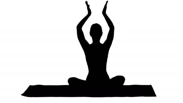 Silhouette Young sporty woman sitting in lotus pose, join hands above her head. — Stock Video