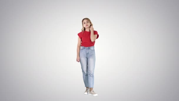 Unhappy and thoughtful young woman in casual on gradient background. — Stock Video