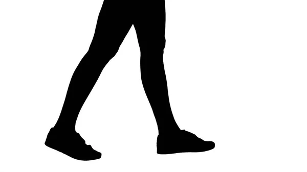 Silhouet van de voeten van de vrouwen het dragen van witte sneaker schoenen lopen. — Stockfoto