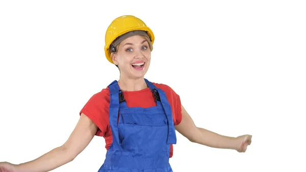 Female construction worker dancing happy on white background. Royalty Free Stock Images