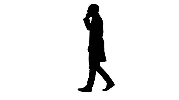 Silhouette Young doctor talking to mobile and walkind. — Stock Photo, Image