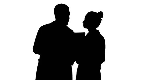 Silhouette Serious nice woman doctor and afro american doctor study brain x ray.
