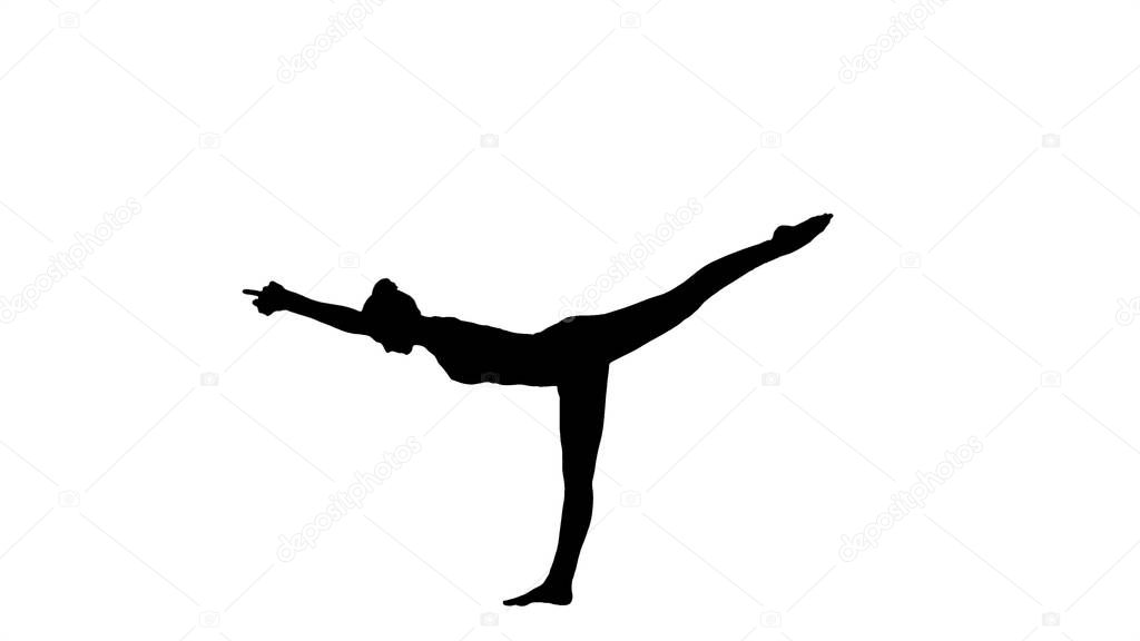 Silhouette Tuladandasana or Balancing Stick Pose is an advanced yoga posture made by beautiful yogi woman.