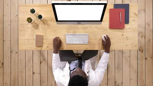 Medical worker typing on the computer. White Display.