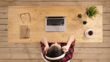 Kulaklıklar giyen ve masada oturan müzik dans genç çekici kadın.