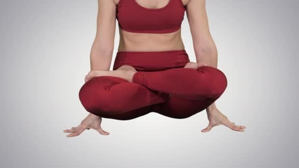 Sporty attractive woman practicing yoga, standing in Scale exercise, Tolasana pose on gradient background. — Stock Video