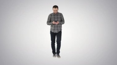 Degrade arka plan üzerinde ileti yürüyüş ve bir telefonu kullanarak genç adam.