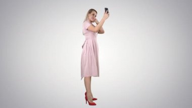 Güzel bir kadın arka planda telefonuna bakıyor..