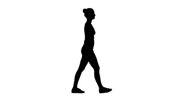 Silhouette Young woman in sportswear taking a walk looking down. — Stock Photo, Image