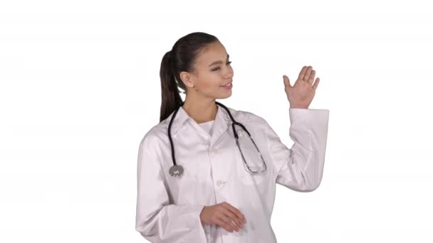 Female doctor showing something with hands extended Presentation on white background. — Stock Video