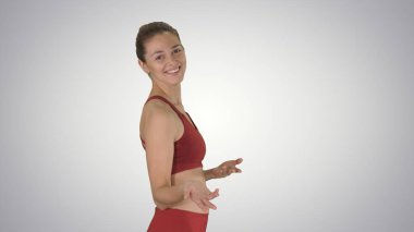 Yoga öğretmeni gradyan arkaplanda yürüyor ve anlatıyor.