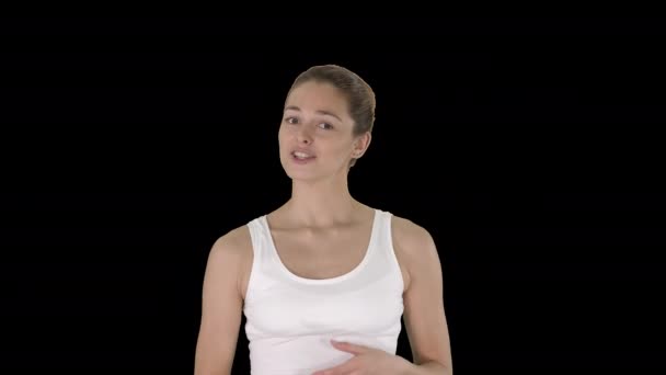 Жінка на білому верхівці щось пояснює під час ходьби Альфа Канал. — стокове відео
