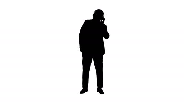 Silhouette Hombre de negocios negro bailando con música en auriculares. — Vídeos de Stock
