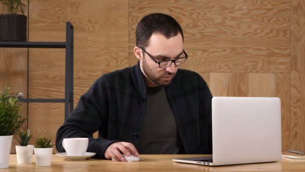 Je me sens fatigué. Frustré jeune homme beau regard épuisé alors qu'il était assis à son lieu de travail et portant ses lunettes à la main — Video