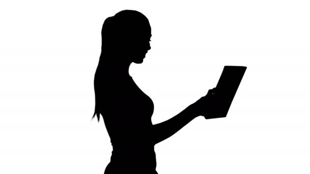 Silhouette Happy woman making a video call with tablet. — Stock Video