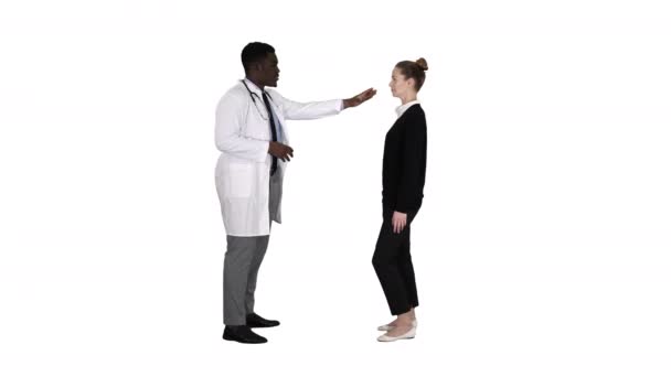 Doctor telling good news and patient leaves on white background. — Stock Video