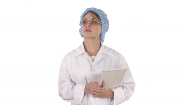 Woman doctor holding tablet and walking on white background. — Stock Video