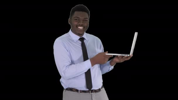 Talking to camera young african man with laptop in his hands, Alpha Channel — Stock Video