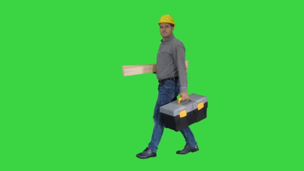 Young happy engineer worker in a helmet showing we did it gesture on a Green Screen, Chroma Key. — Stock video