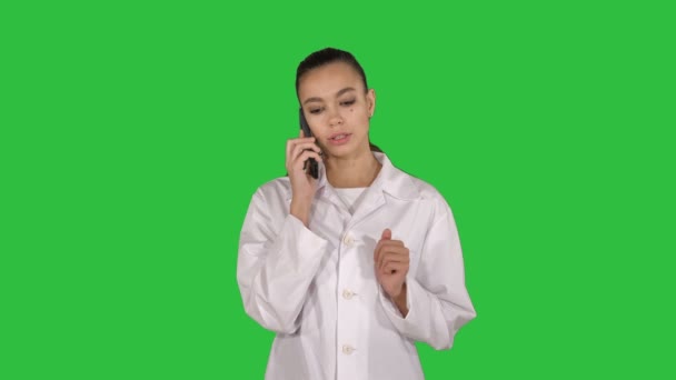 Confident female doctor, healthcare professional talking on phone with patient on a Green Screen, Chroma Key. — Stock Video