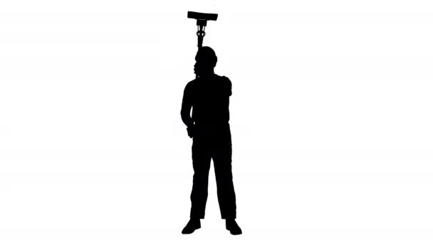 Silhouette Smiling mid adult worker cleaning window with squeegee and smiling to camera. — Stock Video