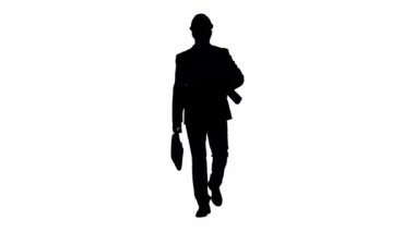 Siluet Erkek mimar bir takım elbise ve sert şapka planları ve evrak çantası ile yürüyüş.