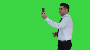 Mutlu genç yakışıklı işadamı kayıt vlog ya da yeşil ekranda video arama yapma, Chroma anahtar.