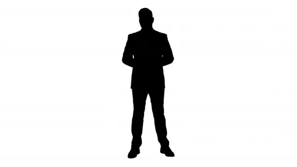 Silhouette Smiling businessman pointing on something and talknig. — Stock Video