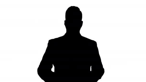 Silhouette Handsome businessman presenting to camera giving three points. — Stock Video