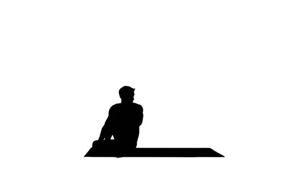 Silhouette Man praktiziert Yoga, dehnt Oberkörper. — Stockfoto