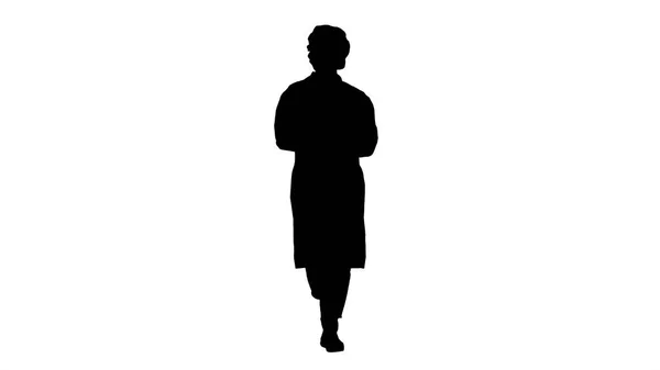 Silhouette Przyjazna kobieta lekarz spaceru i rozmowy do kamery. — Zdjęcie stockowe